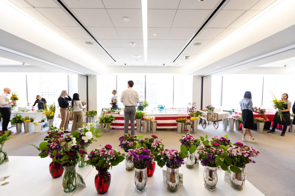 Table of completed floral arrangements made by event participants